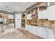 Modern kitchen with granite countertops, stainless steel appliances, hardwood floors, and custom cabinetry at 909 143Rd Ne St, Bradenton, FL 34212