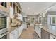 Gourmet kitchen with granite counters, stainless appliances, custom backsplash, island, and ample cabinet space at 909 143Rd Ne St, Bradenton, FL 34212