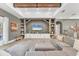 Cozy living room featuring a gray sectional sofa, fireplace, and stylish decor, creating a relaxing atmosphere at 909 143Rd Ne St, Bradenton, FL 34212