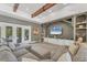 Spacious living room with hardwood floors, wooden beams, grey walls, and a large comfortable sectional sofa at 909 143Rd Ne St, Bradenton, FL 34212