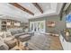 Spacious living room with exposed beams, open floor plan and view of outdoor patio at 909 143Rd Ne St, Bradenton, FL 34212