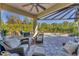 Inviting outdoor living space with a built-in grill, comfortable seating, and a refreshing swimming pool in the background at 909 143Rd Ne St, Bradenton, FL 34212