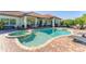 Gorgeous pool and spa with a brick paver deck and lush landscaping, creating a private retreat at 909 143Rd Ne St, Bradenton, FL 34212