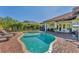 Backyard pool and spa surrounded by brick pavers and lush landscaping for a private, resort-like experience at 909 143Rd Ne St, Bradenton, FL 34212