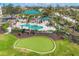 Aerial view of community amenities: putting green, pool, lush landscaping, and well-maintained grounds at 9203 Griggs Rd # B102, Englewood, FL 34224