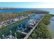 Aerial view of boat slips in marina surrounded by lush green vegetation, docks and boat lifts at 9203 Griggs Rd # B102, Englewood, FL 34224