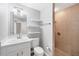 Bathroom with a floating shelf, a neutral vanity, and a glass-door shower in the corner at 9203 Griggs Rd # B102, Englewood, FL 34224