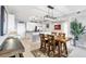 Bright dining area with a wooden table set and views to the kitchen in this spacious condominium at 9203 Griggs Rd # B102, Englewood, FL 34224