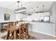 Dining room with seating for four plus views of the modern kitchen area with stainless steel appliances at 9203 Griggs Rd # B102, Englewood, FL 34224
