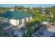 Aerial view of a resort-style community with a pool, lounge area, and lush landscaping at 9203 Griggs Rd # B102, Englewood, FL 34224