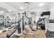 Well-equipped fitness room with a variety of exercise machines and mirrored walls at 9203 Griggs Rd # B102, Englewood, FL 34224