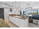 Modern kitchen featuring granite countertops, stainless steel appliances, and a view to the dining and living areas at 9203 Griggs Rd # B102, Englewood, FL 34224