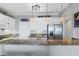 Modern kitchen with granite countertops, stainless steel appliances, and pendant lighting at 9203 Griggs Rd # B102, Englewood, FL 34224