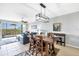 Open-concept living area with tile flooring, leading to a balcony with scenic outdoor views and water at 9203 Griggs Rd # B102, Englewood, FL 34224