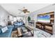 Inviting living room with open floor plan to kitchen, stylish furniture, and decorative accents at 9203 Griggs Rd # B102, Englewood, FL 34224