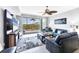 Open living room with a ceiling fan and sliding glass doors to the balcony featuring a stunning view at 9203 Griggs Rd # B102, Englewood, FL 34224