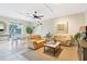 Bright and open living room featuring comfortable seating, tile floors, and adjacent dining area at 9203 Griggs Rd # B102, Englewood, FL 34224
