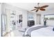 Bright main bedroom with an ensuite bathroom and sliding glass doors to the outdoor balcony at 9203 Griggs Rd # B102, Englewood, FL 34224