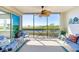 Enjoy the scenic lake views from this screened-in patio with seating and decor at 9203 Griggs Rd # B102, Englewood, FL 34224