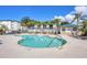 Community swimming pool surrounded by lush landscaping and comfortable lounge chairs for relaxing at 9203 Griggs Rd # B102, Englewood, FL 34224