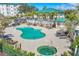 Resort-style pool and hot tub with comfortable lounge seating and well-maintained grounds in the community at 9203 Griggs Rd # B102, Englewood, FL 34224