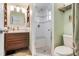 Beautiful bathroom featuring a glass shower, tiled seat, modern vanity, and organized shelving for toiletries at 9619 Valencia Cv, Bradenton, FL 34210