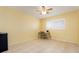 Sunny bedroom featuring a large window, tile flooring, and a small desk area, ideal for a home office setup at 9619 Valencia Cv, Bradenton, FL 34210