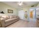 Comfortable bedroom features a convertible couch and closet, offering a versatile space for relaxation and storage at 9619 Valencia Cv, Bradenton, FL 34210