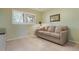 Inviting bedroom with a large window, a convertible sofa, and ample space for a relaxing retreat at 9619 Valencia Cv, Bradenton, FL 34210