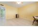 Bright and airy bedroom with tiled flooring, a mini-fridge, desk, and a large window, creating a comfortable living space at 9619 Valencia Cv, Bradenton, FL 34210