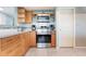 Updated kitchen featuring stainless steel oven and maple cabinets with tile backsplash at 9619 Valencia Cv, Bradenton, FL 34210