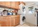 Functional laundry room with stacked washer/dryer and ample cabinet space at 9619 Valencia Cv, Bradenton, FL 34210