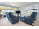 Relaxing living space with comfy seating, tile flooring, and a large window for natural light at 9619 Valencia Cv, Bradenton, FL 34210