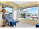 Bright sunroom featuring tiled floors, water views, and comfortable seating to enjoy the scenery at 9619 Valencia Cv, Bradenton, FL 34210