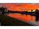 Breathtaking waterfront view with a vibrant sunset reflecting off the water, showcasing the tranquil beauty of the location at 9619 Valencia Cv, Bradenton, FL 34210