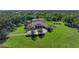 Sprawling estate featuring a circular driveway, luxurious home, solar panels, and manicured lawns at 1110 79Th E St, Palmetto, FL 34221