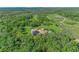 Wide aerial view showcasing a private estate, including the home, landscaping, pool, solar panels, and surrounding greenery at 1110 79Th E St, Palmetto, FL 34221