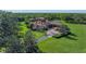 Expansive estate showcasing lush landscaping, a circular driveway, and a beautiful home with a red tile roof at 1110 79Th E St, Palmetto, FL 34221