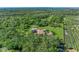 Gorgeous estate with mature trees and landscaping from an aerial vantage point with solar panels and large grassy yard at 1110 79Th E St, Palmetto, FL 34221
