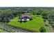 Scenic aerial view of a home with solar panels, lush greenery, and a long driveway at 1110 79Th E St, Palmetto, FL 34221