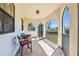 Covered balcony with tile flooring and railings overlooks greenery in the distance at 1110 79Th E St, Palmetto, FL 34221