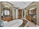 Well-appointed bathroom featuring dual vanities, a soaking tub, and ample storage offers a functional and stylish space at 1110 79Th E St, Palmetto, FL 34221