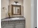 Powder room featuring a decorative mirror, mosaic countertop, and a vessel sink at 1110 79Th E St, Palmetto, FL 34221