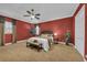 Carpeted bedroom features a fan, bedside tables, and large picture window at 1110 79Th E St, Palmetto, FL 34221