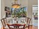 Cozy dining area with a view of the pool and lush tropical landscaping at 1110 79Th E St, Palmetto, FL 34221