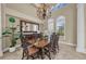 Elegant dining room featuring a large table, chairs, a statement mirror, and bright windows with custom shutters at 1110 79Th E St, Palmetto, FL 34221