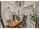 Formal dining room featuring tray ceiling, elegant lighting, and large dining table with seating for formal occasions at 1110 79Th E St, Palmetto, FL 34221