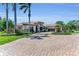 Elegant home featuring a grand entrance, well-manicured landscaping, and a circular driveway at 1110 79Th E St, Palmetto, FL 34221