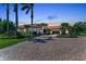 Elegant home featuring a tile roof, arched entryway, circular driveway, and manicured landscaping at 1110 79Th E St, Palmetto, FL 34221