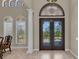 Elegant foyer with arched doorways, decorative windows, and a grand column at 1110 79Th E St, Palmetto, FL 34221